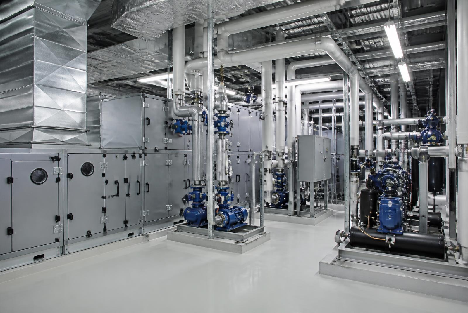 Representative commercial mechanical-equipment room with air handling, pumping, piping and refrigeration assemblies.